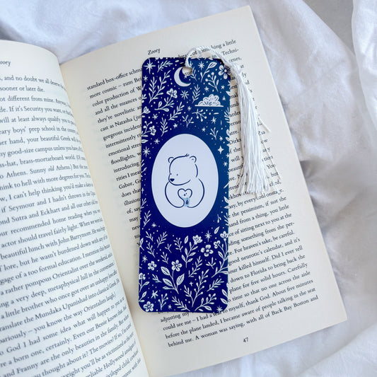 Blue floral bookmark with a white bear design on an open book