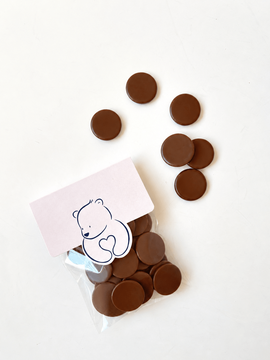 Chocolate buttons with a small bag on a white background