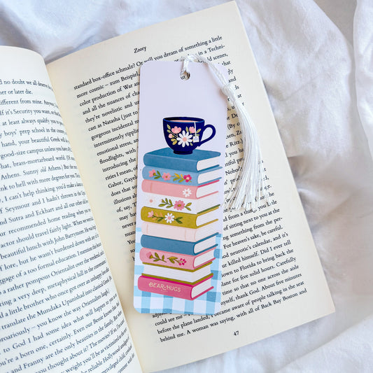 Bookmark with a design of books and a cup on an open book