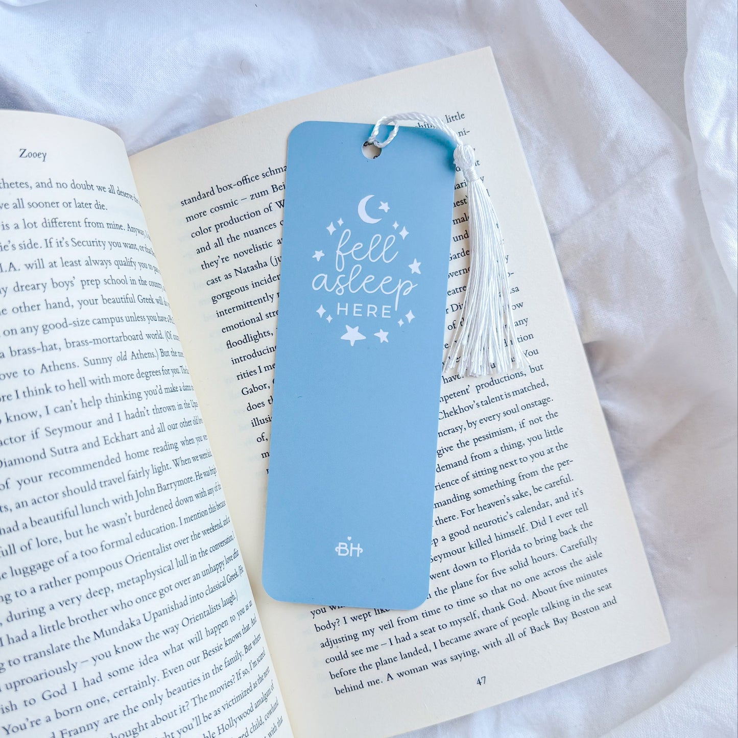 Blue bookmark with tassel on an open book