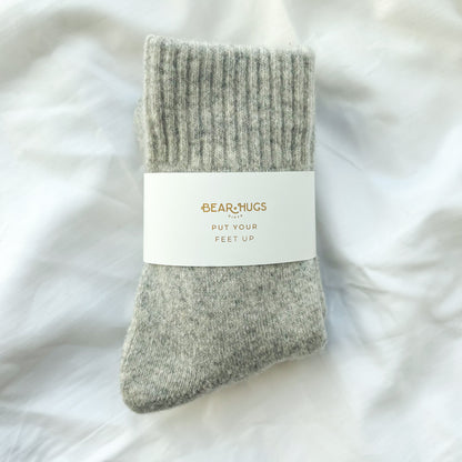 Gray sock with a label on a white fluffy background